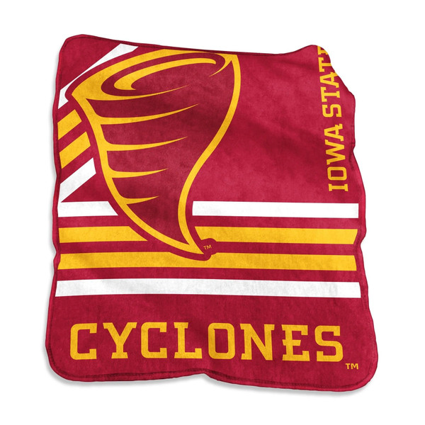 Student sitting on a dorm bed covered in the Iowa State Cyclones 50×60 Raschel Throw Blanket, smiling with laptop, surrounded by red and gold team-themed décor and game-day gear