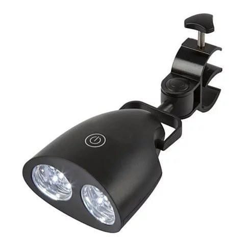 Grill Star LED Grill Light clipped to a gas grill illuminating steaks and burgers for nighttime BBQs.