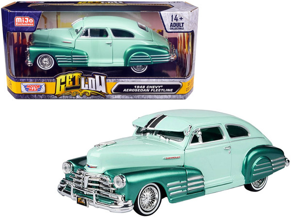 1948 Chevrolet Aerosedan Fleetside Lowrider 1/24 diecast model by Motormax in pastel green and metallic green two-tone finish, featuring chrome accents, whitewall tires, and fully opening doors, hood, and trunk, displayed on a collector’s shelf in window box packaging.