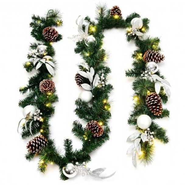 9-foot pre-lit artificial Christmas garland with warm white LED lights fully extended on white background, showing dense pine foliage and wired flexibility.