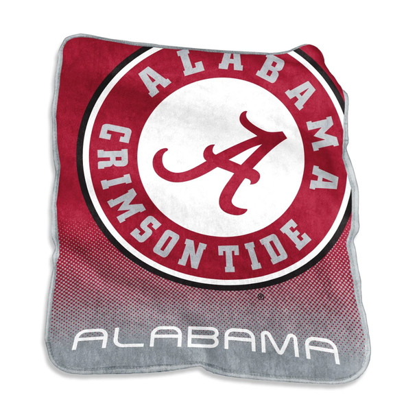 Alabama Crimson Tide 50×60 Raschel Throw Blanket draped over a gray couch with vibrant team logo and colors visible, creating a cozy game day atmosphere Alabama Crimson Tide 50×60 Raschel Throw Blanket draped over a gray couch with vibrant team logo and colors visible, creating a cozy game day atmosphere
