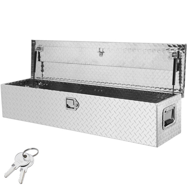 48-inch diamond plate aluminum truck bed tool box with dual key lock and side handles securely mounted behind pickup cab, weather-sealed and reflecting sunlight on brushed silver finish.