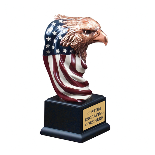 Hand-painted American bald eagle head sculpture with flowing American flag body detail, stars and stripes, mounted on black piano-finish base with custom engraved gold plate — personalized patriotic and corporate recognition award from Trophy Outlet