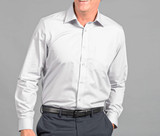 A light grey button-up shirt with a chest pocket, worn by a smiling man against a grey background.