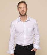 A button-up shirt in white, featuring a front pocket and long sleeves, modelled by a man against a neutral background.