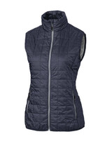 A dark grey puffer vest with a zip front and high collar, featuring two side pockets and a branding logo. A dark grey puffer vest with a zip front and high collar, featuring two side pockets and a branding logo.