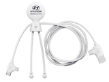 A white charging cable with three connectors and a round, branded head. The cables are flexible and neatly arranged. A white charging cable with three connectors and a round, branded head. The cables are flexible and neatly arranged.