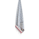 A lightweight beach towel in white and blue with geometric patterns and a red border, featuring tassels at the ends. A lightweight beach towel in white and blue with geometric patterns and a red border, featuring tassels at the ends.
