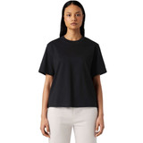 A black box tee featuring a relaxed fit and short sleeves, paired with light-coloured dress shorts.