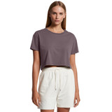 A model wearing a dark grey cropped t-shirt paired with light-coloured shorts. The shirt has a logo. A model wearing a dark grey cropped t-shirt paired with light-coloured shorts. The shirt has a logo.
