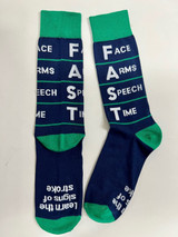 A pair of navy blue socks with green accents, featuring the acronym "FAST" and associated words printed on them. A pair of navy blue socks with green accents, featuring the acronym "FAST" and associated words printed on them.