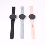 A set of three smartwatches featuring black, gray, and pink straps, each with a round black screen and a metallic casing.