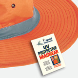 An orange safety hat with a wide brim and a grey band, featuring a logo and a tag for UV protective headwear.
