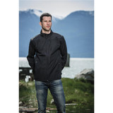 A man stands outdoors wearing a black softshell jacket, with mountains and water in the background. The jacket has a logo. A man stands outdoors wearing a black softshell jacket, with mountains and water in the background. The jacket has a logo.