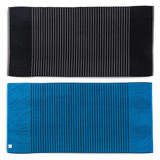 A reversible two-tone towel featuring black with stripes on one side and blue with stripes on the other side. It has a logo.