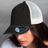A black and cream trucker cap featuring a mesh back and a curved visor, with a logo on the side.