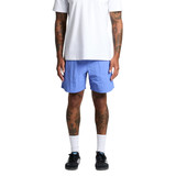 Swim shorts in light blue, featuring a casual fit and knee-length design, worn by a person with tattoos.