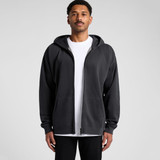 A person wearing a black zip-up hoodie with a front zip and an attached hood, featuring a logo.