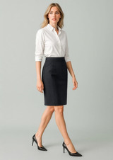 A fitted women's pencil skirt in dark navy, paired with a white button-up shirt and black heels.