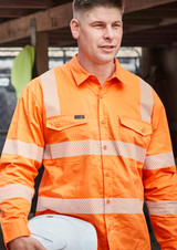 An orange long-sleeve work shirt with segmented reflective tape and a logo, worn by a man holding a white hard hat.