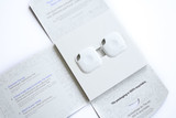 A white two-pack of Tile Mate products inside a light grey packaging with a logo. A white two-pack of Tile Mate products inside a light grey packaging with a logo.
