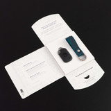 A black Tile Pro and a blue genuine leather key fob displayed in an open package on a dark background. A black Tile Pro and a blue genuine leather key fob displayed in an open package on a dark background.