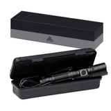 A black torch is inside a hard case, displayed with a sleek black box in the background. The torch has a clip and button.