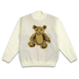 A cream jumper with a knitted teddy bear design in brown tones. It features a round neck and ribbed cuffs. A cream jumper with a knitted teddy bear design in brown tones. It features a round neck and ribbed cuffs.