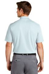 A light blue Nike Dri-FIT Micro Pique 2.0 polo shirt is displayed, featuring short sleeves and a collar. A light blue Nike Dri-FIT Micro Pique 2.0 polo shirt is displayed, featuring short sleeves and a collar.