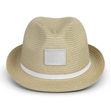 A straw fedora hat in light beige with a white band, featuring a blank patch for branding.