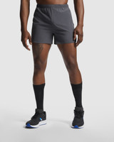 Sporty grey running shorts with an elastic waistband and branding, paired with black socks and footwear.