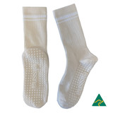 Crew Grip socks in cream with textured grips on the soles, featuring a logo on the side.