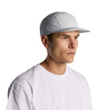 A man wearing a light grey Finn Nylon Cap, paired with a simple white T-shirt. The cap features a branding logo.