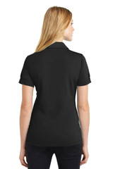 A black polo shirt displayed on a model from the back, featuring short sleeves and a collar.