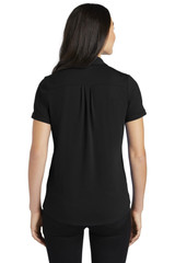 A black women's polo shirt with short sleeves and a subtle pleat detail at the back. It features a logo.