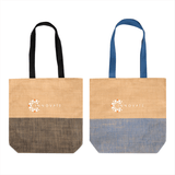 Two tote bags, one with black handles and a black patterned base, the other with blue handles and a blue patterned base. Both feature a logo.