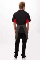 A black and grey bistro apron worn by a person, with a red shirt visible from the back. Features a logo.