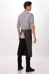 A man wearing a black Boulder Bistro apron over casual attire, showcasing the back of the apron.