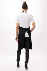 A black Brio Bib Apron worn over a white shirt, displaying a stylish back design.