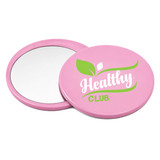 A pink circular makeup mirror with a reflective surface and a logo featuring green design elements.