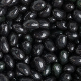 A close-up of shiny black jelly beans, showcasing their smooth, glossy surface and varied shapes.