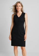 A sleeveless V-neck dress in black, featuring a fitted design and a smooth fabric. The model presents a relaxed pose.