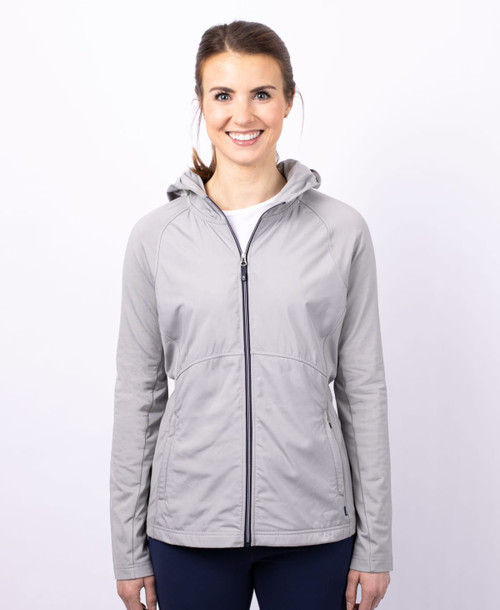 A grey full zip ladies' jacket with a hood, featuring a branded logo on the front. A grey full zip ladies' jacket with a hood, featuring a branded logo on the front.