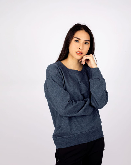 A navy crew neck sweatshirt for women, featuring a relaxed fit and long sleeves, with a logo on the front. A navy crew neck sweatshirt for women, featuring a relaxed fit and long sleeves, with a logo on the front.