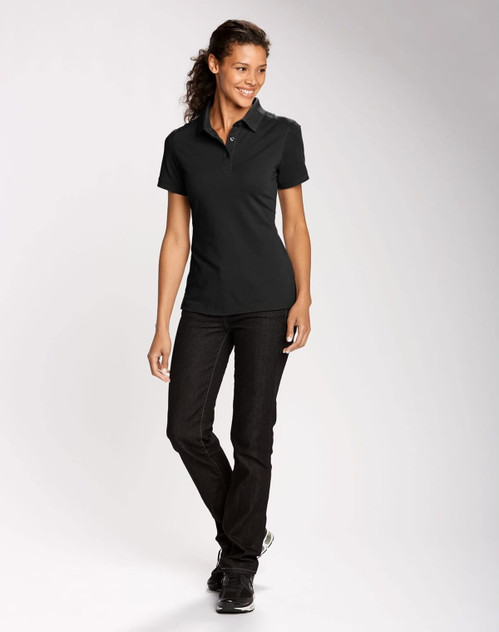 A black women's polo shirt paired with dark jeans, featuring a collar and a logo. A black women's polo shirt paired with dark jeans, featuring a collar and a logo.