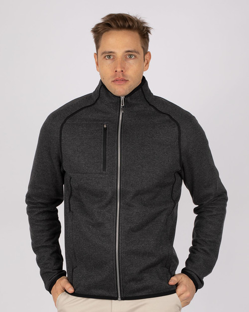 A men's full zip jacket in dark grey, featuring a sleek design and a zippered chest pocket. It has a logo. A men's full zip jacket in dark grey, featuring a sleek design and a zippered chest pocket. It has a logo.