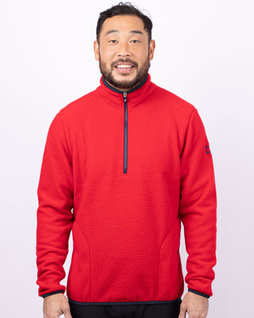 A man wearing a bright red half-zip fleece jacket with a zippered collar and a logo on the sleeve. A man wearing a bright red half-zip fleece jacket with a zippered collar and a logo on the sleeve.