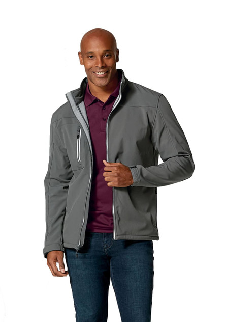 A man models a grey softshell jacket with a zippered pocket and a logo on the chest. He wears a purple polo underneath. A man models a grey softshell jacket with a zippered pocket and a logo on the chest. He wears a purple polo underneath.