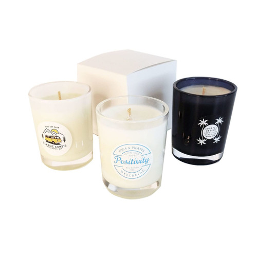 Three votive glass candles in clear and black containers, featuring various designs, displayed with a white box. Three votive glass candles in clear and black containers, featuring various designs, displayed with a white box.