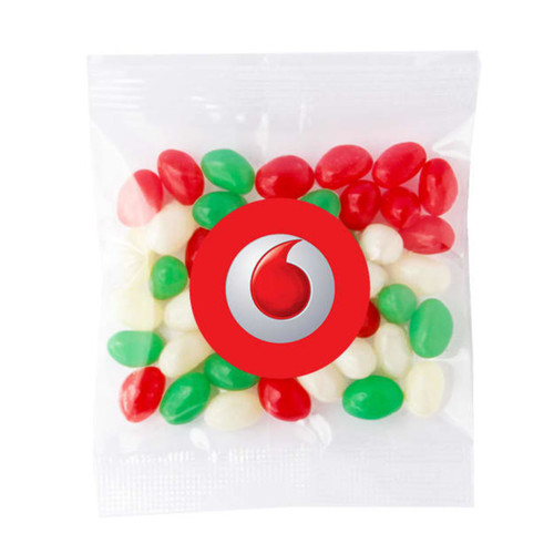 A clear bag contains red, green, and white jelly beans, with a logo printed on the front. A clear bag contains red, green, and white jelly beans, with a logo printed on the front.